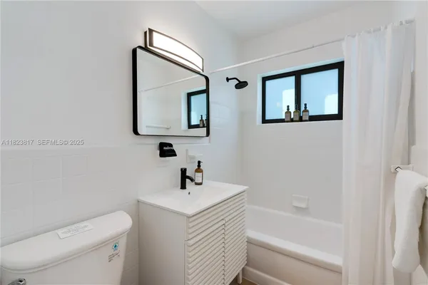 a white toilet sitting next to a bathroom sink