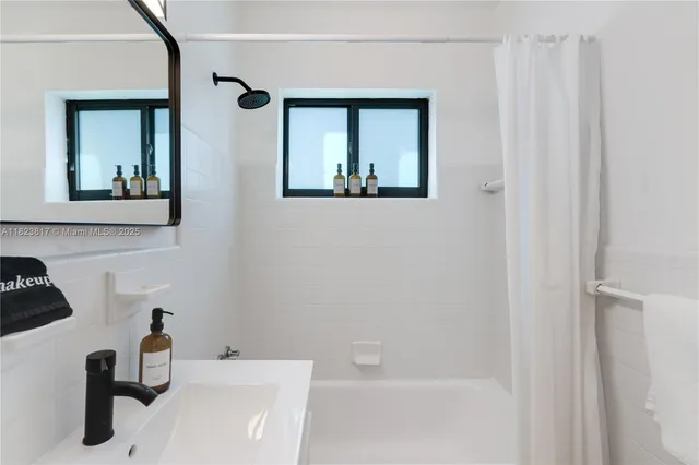 a bathroom with a sink a mirror and a bathtub