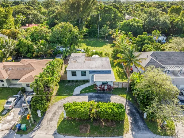 an aerial view of a house with a yard