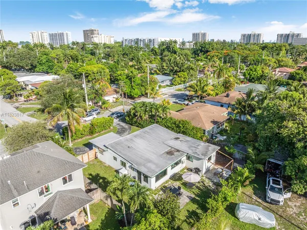an aerial view of multiple houses with yard