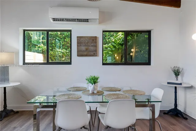 a view of a dining room with furniture window and wooden floor