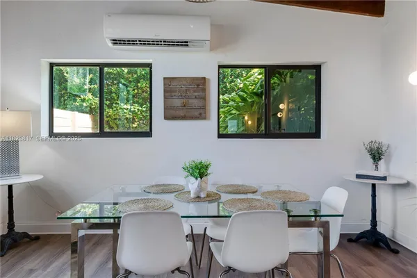 a view of a dining room with furniture window and wooden floor