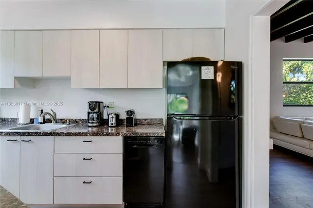 a kitchen with a refrigerator and cabinets