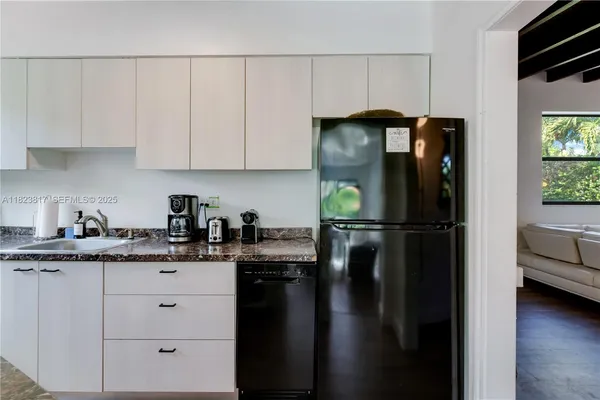 a kitchen with a refrigerator and cabinets