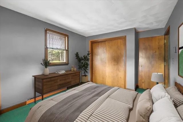 a bedroom with a bed and a dresser