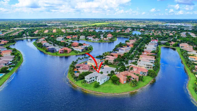 an aerial view of residential houses with outdoor space and trees