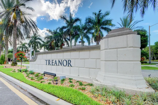 an aerial view of ocean and residential houses with outdoor space