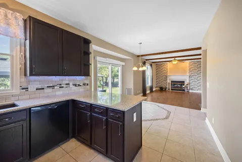 a kitchen with a sink window and cabinets