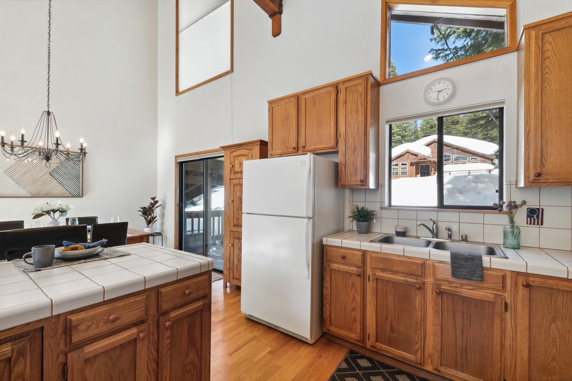 11400 Sitzmark Way Truckee, CA 96161 - Photo 12 of 21 a kitchen with a refrigerator a stove a sink dishwasher and wooden cabinets