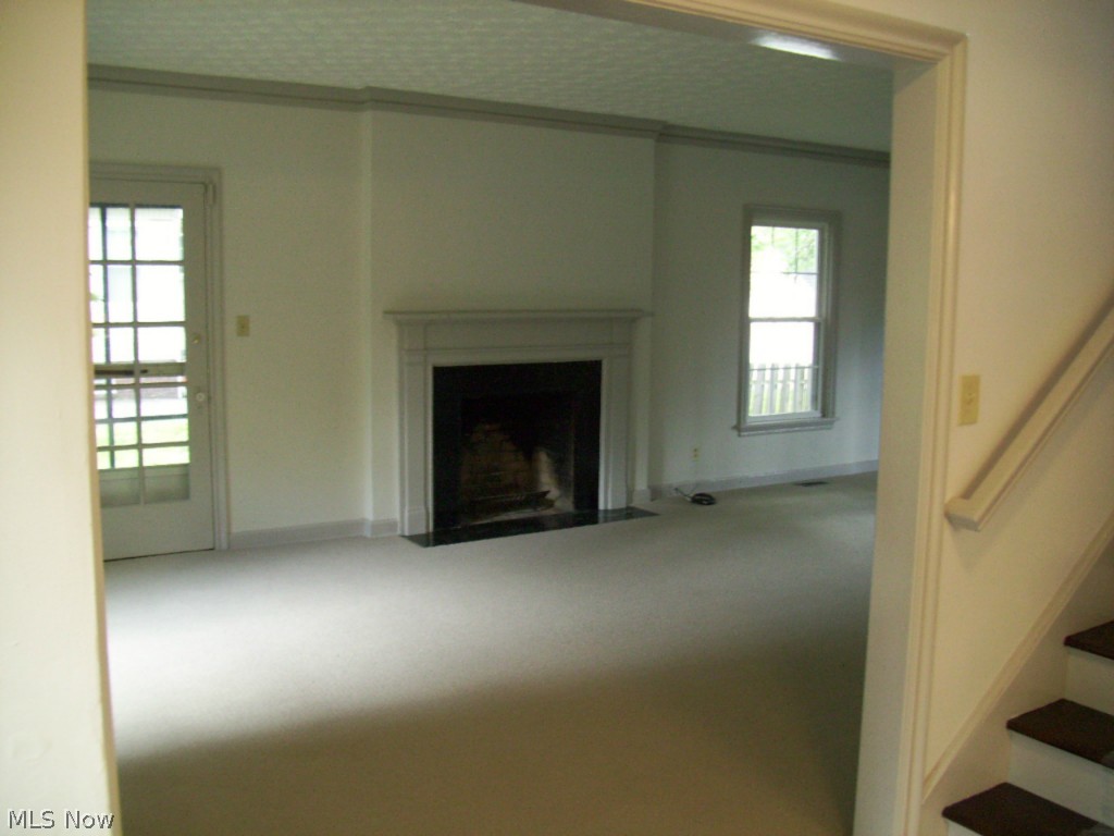 1512 Compton Road Cleveland, OH 44118 - Photo 3 of 25 Living room: entry to side 8 x 17 screened-in porch, wood burning fireplace with marble fascia, crown moldings at ceiling.