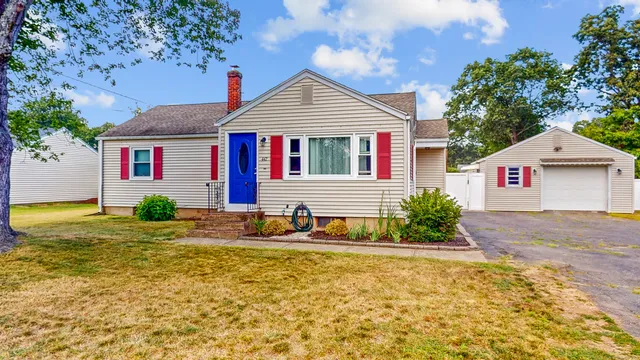 a view of a house with backyard and sitting area