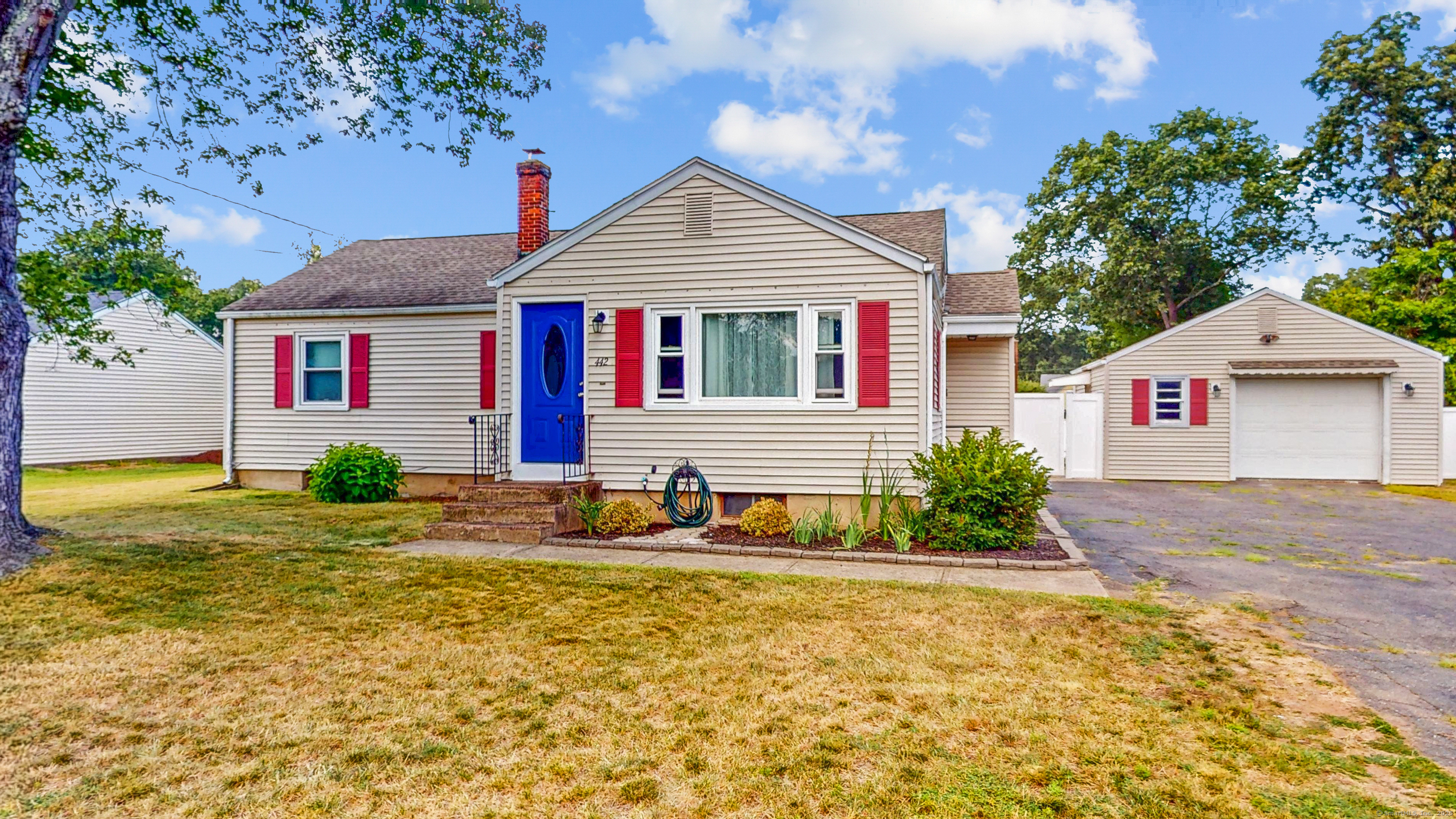 a view of a house with backyard and sitting area