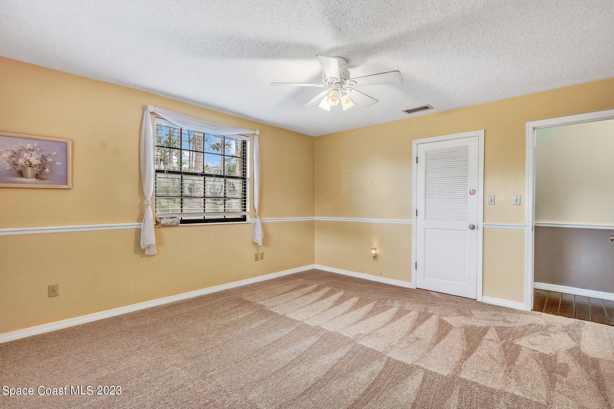 2281 Friday Road Cocoa, FL 32926 - Photo 11 of 72 an empty room with windows and fan
