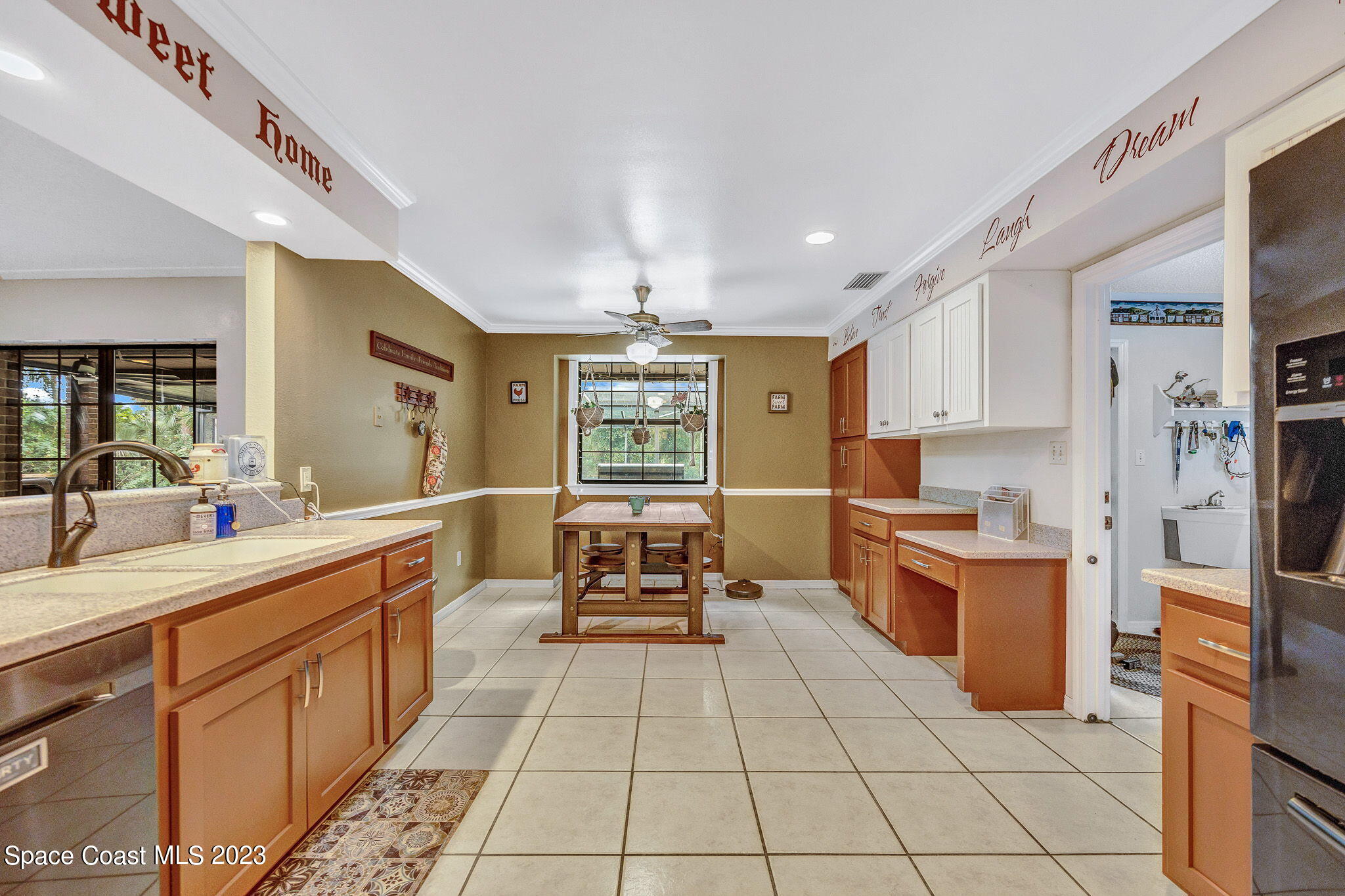 2281 Friday Road Cocoa, FL 32926 - Photo 27 of 72 a large kitchen with stainless steel appliances a stove a sink dishwasher and cabinets