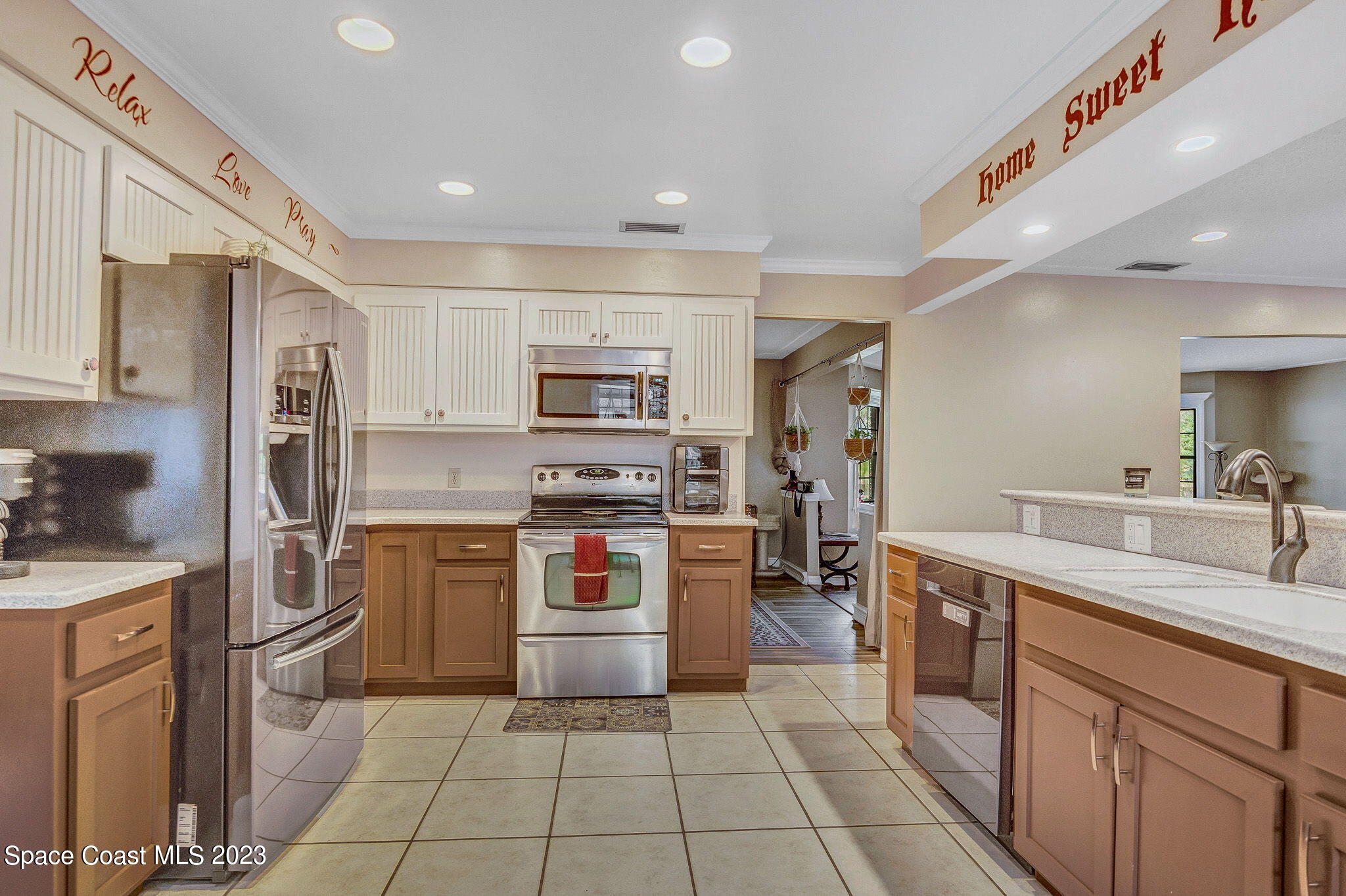 2281 Friday Road Cocoa, FL 32926 - Photo 31 of 72 a kitchen with stainless steel appliances granite countertop a refrigerator and a sink
