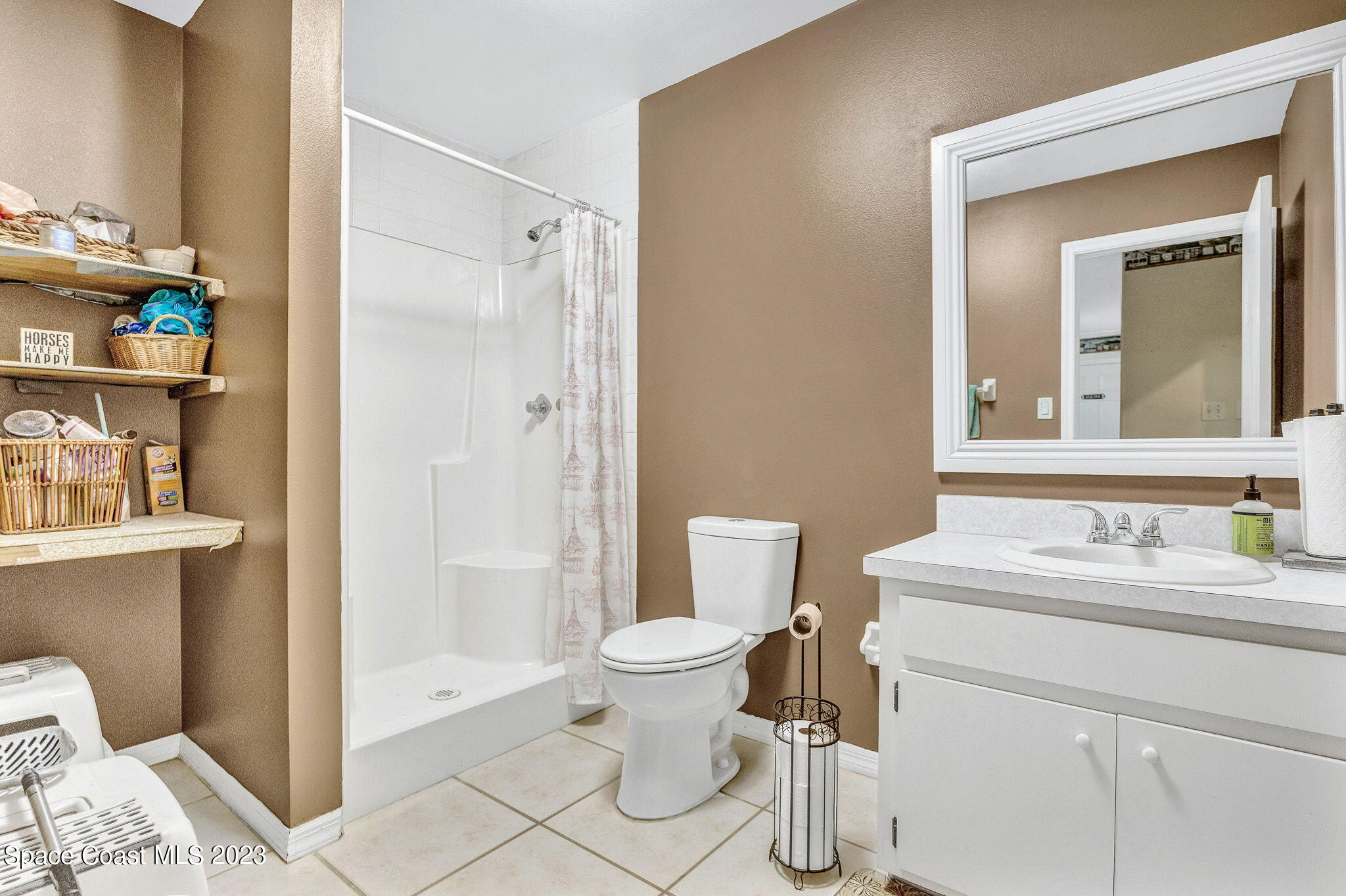 2281 Friday Road Cocoa, FL 32926 - Photo 34 of 72 a bathroom with a sink toilet vanity and shower