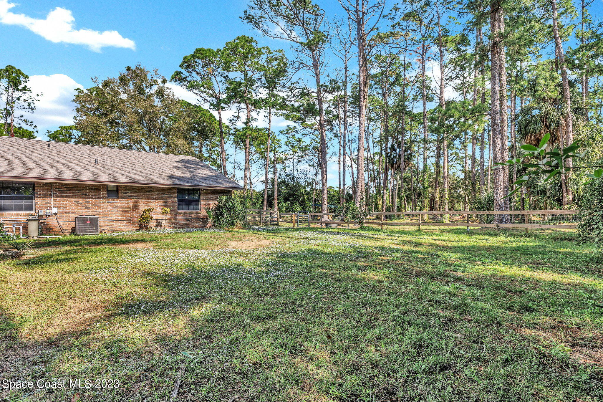 2281 Friday Road Cocoa, FL 32926 - Photo 46 of 72 a view of a big house with a big yard and large trees