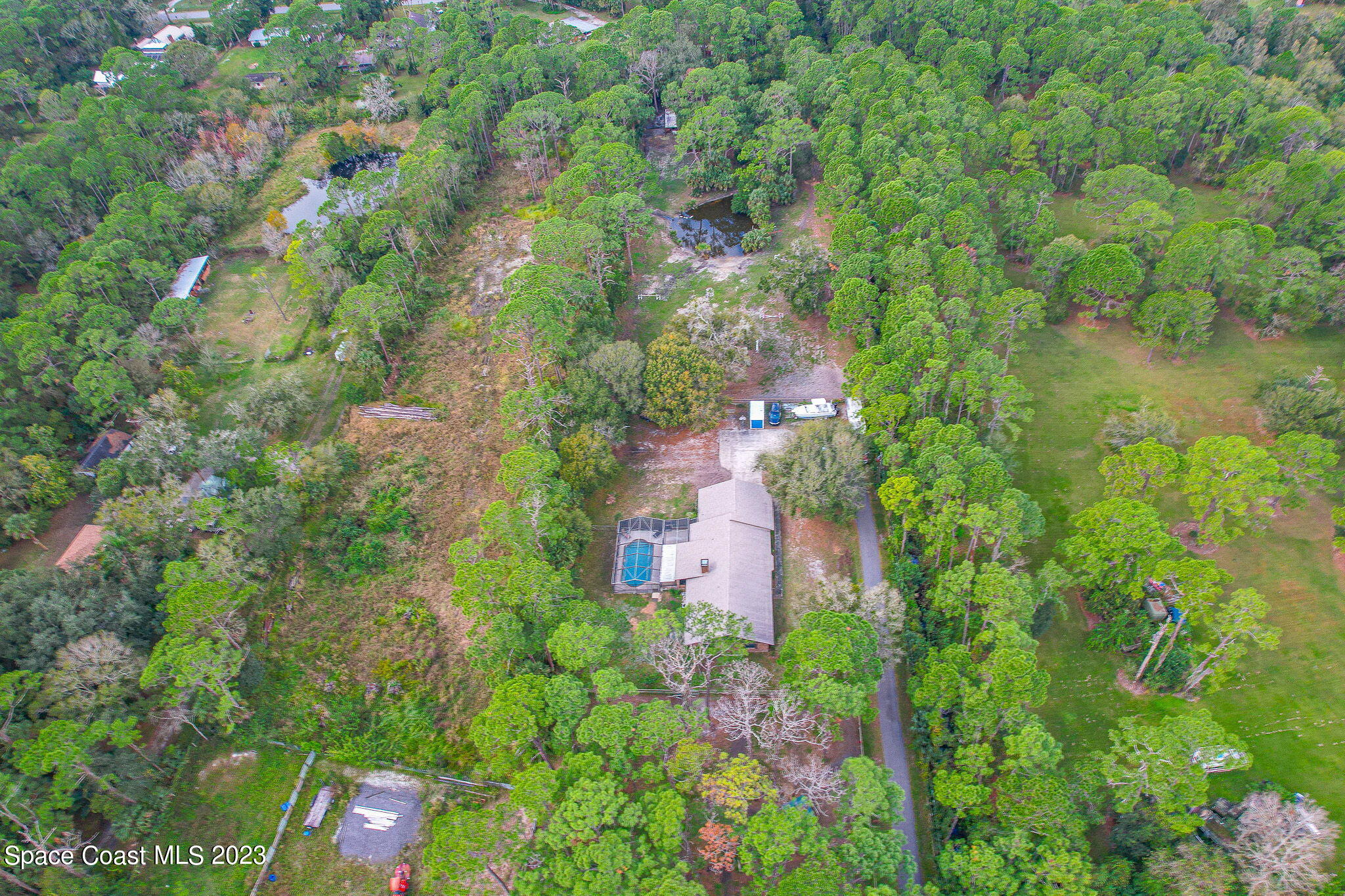2281 Friday Road Cocoa, FL 32926 - Photo 58 of 72 a aerial view of a house with a yard and large trees