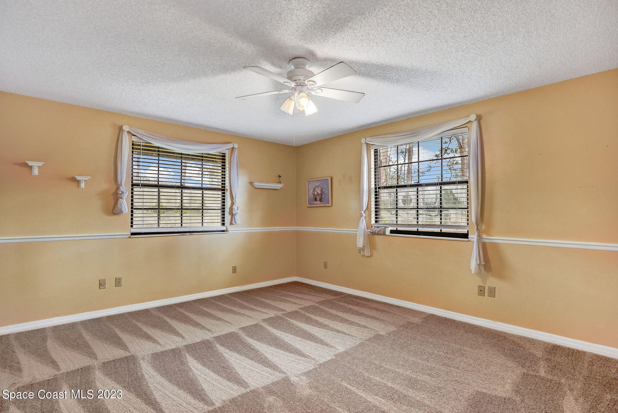 2281 Friday Road Cocoa, FL 32926 - Photo 10 of 72 a view of a room with windows and ceiling fan