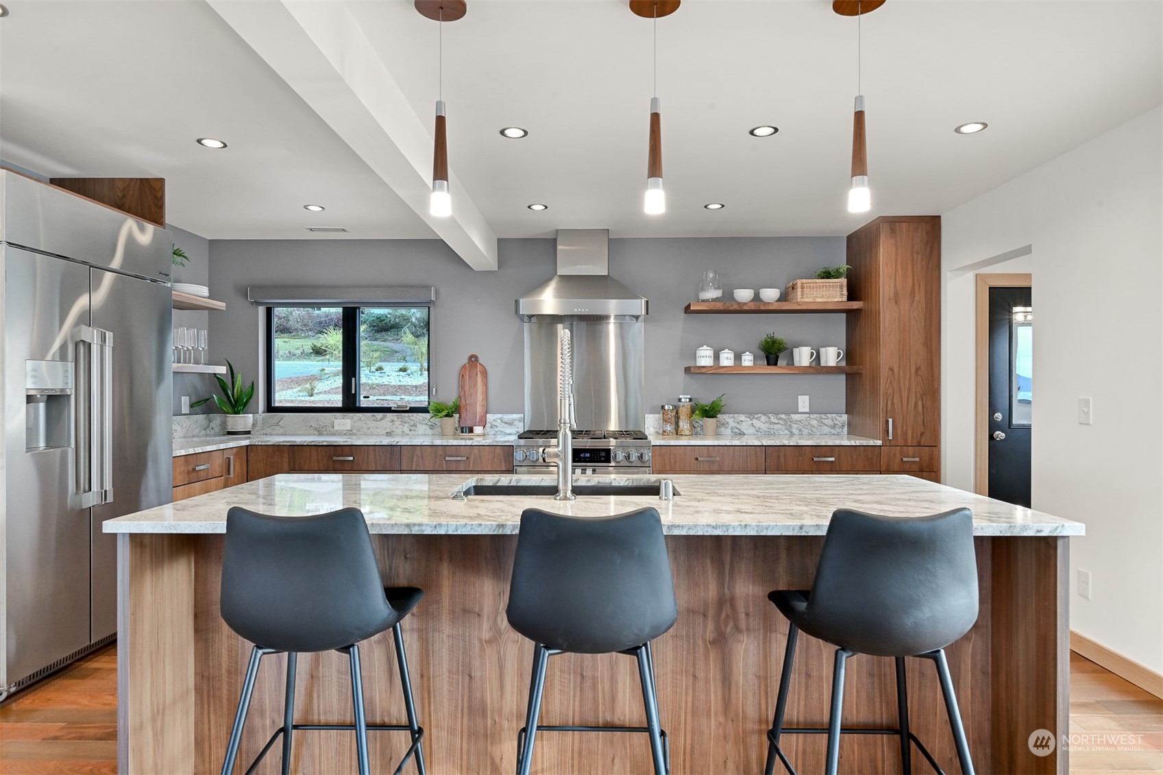 426 Bayside Road Bellingham, WA 98225 - Photo 11 of 42 a kitchen with stainless steel appliances granite countertop a dining table chairs and a refrigerator