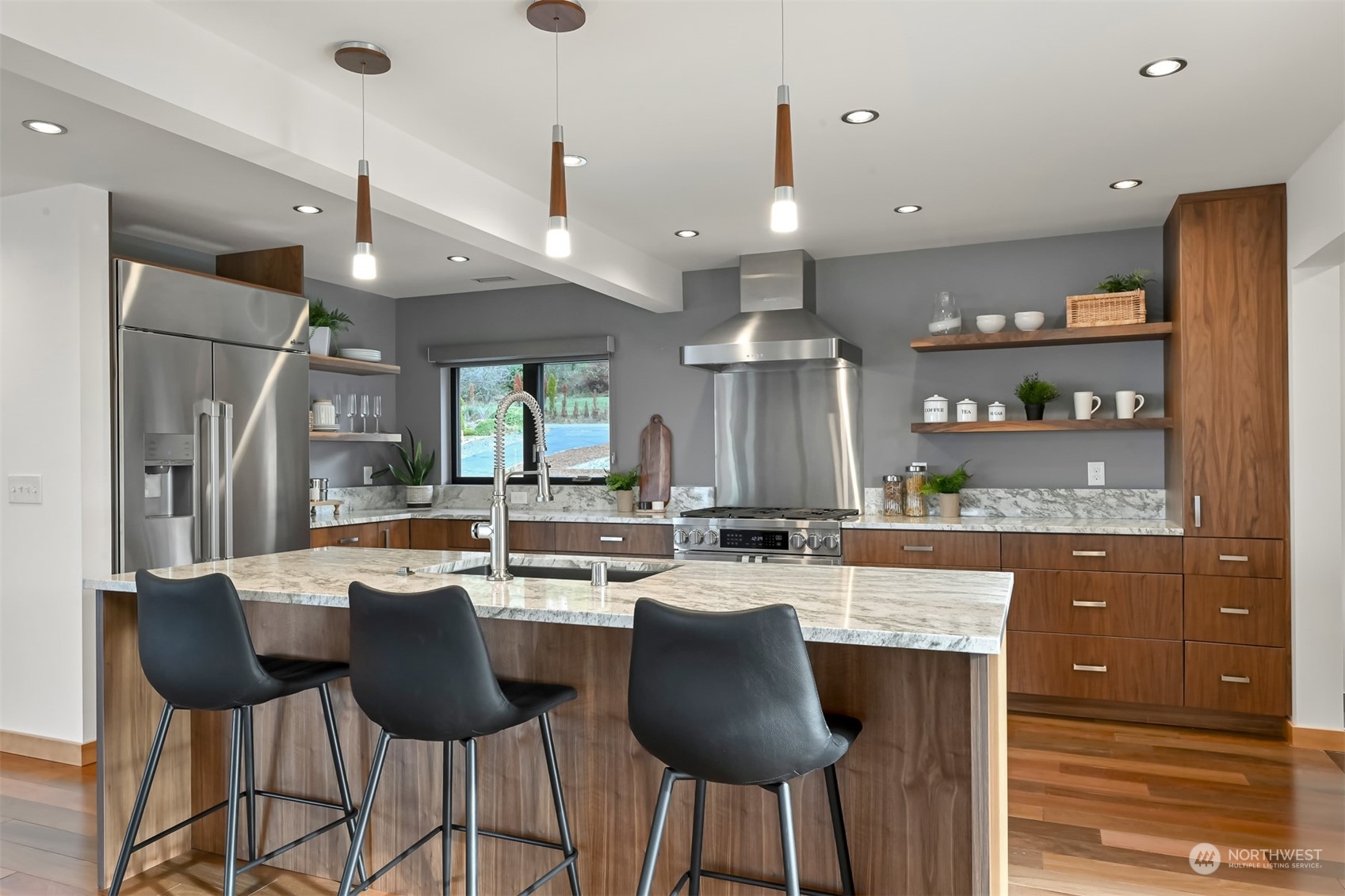 426 Bayside Road Bellingham, WA 98225 - Photo 12 of 42 a kitchen with stainless steel appliances granite countertop a sink a stove a refrigerator and island with wooden floor