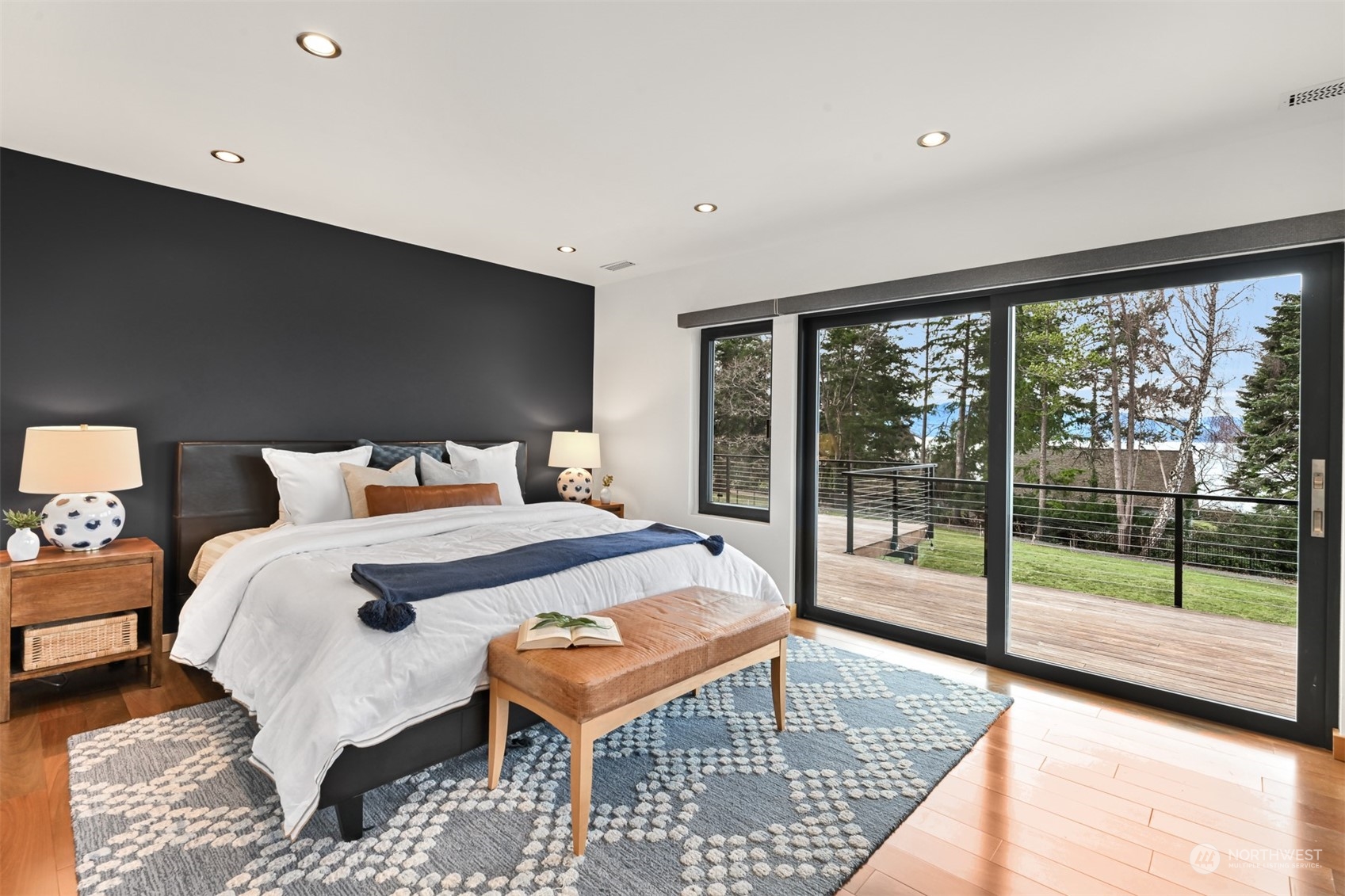 426 Bayside Road Bellingham, WA 98225 - Photo 17 of 42 a bedroom with a bed and glass door