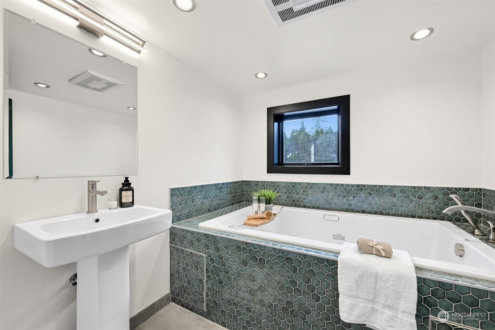 426 Bayside Road Bellingham, WA 98225 - Photo 28 of 42 a bathroom with a tub a sink and mirror