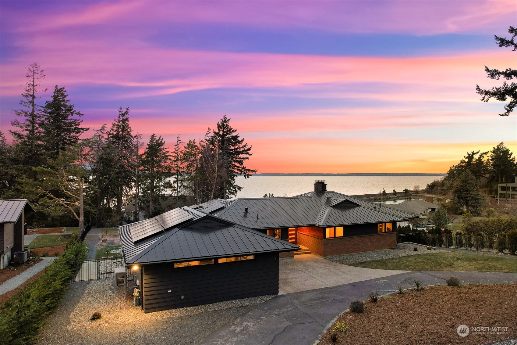 426 Bayside Road Bellingham, WA 98225 - Photo 36 of 42 a roof view of a house with a yard sitting space and fir pit
