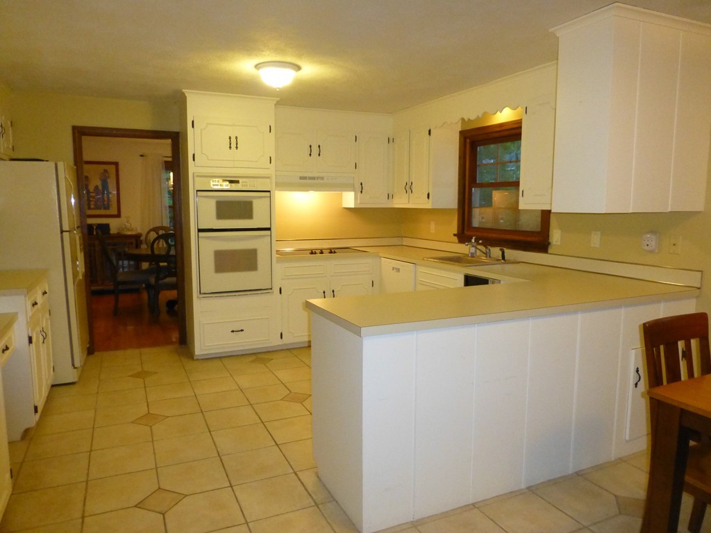 18 Grist Mill Road Acton, MA 01720 - Photo 3 of 30 a view of a kitchen with wooden floor