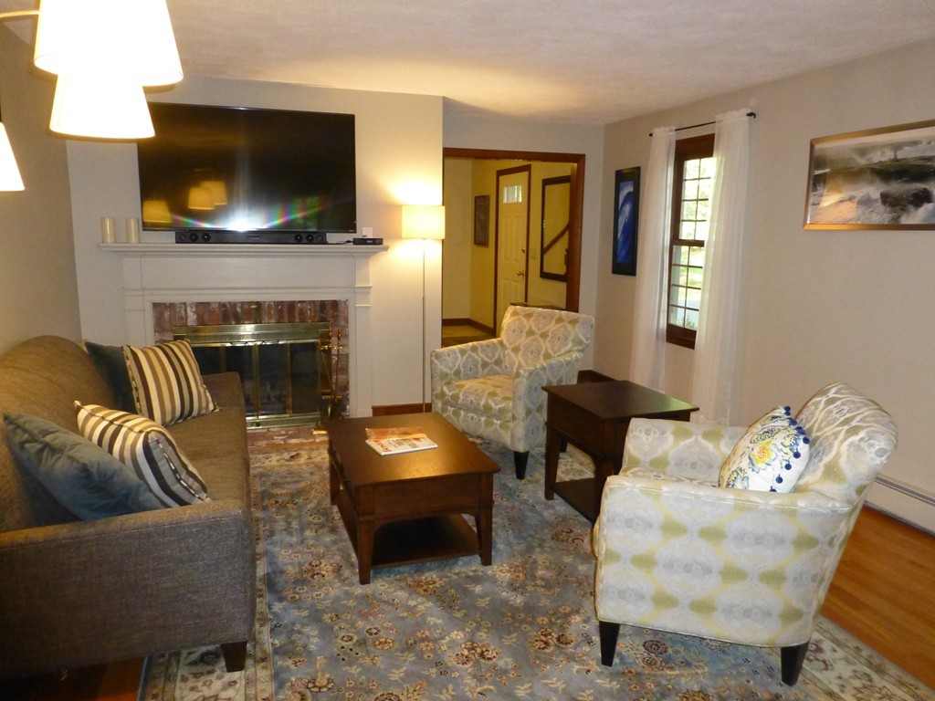 18 Grist Mill Road Acton, MA 01720 - Photo 8 of 30 a living room with furniture and a flat screen tv