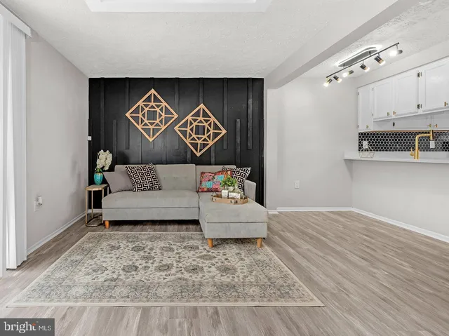 a living room with furniture and kitchen view