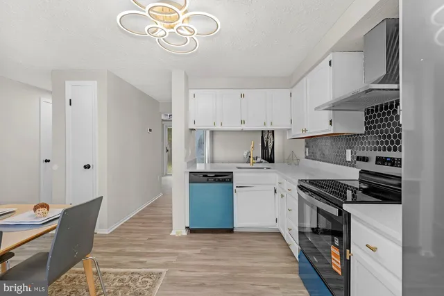 a kitchen with stainless steel appliances granite countertop a sink and cabinets