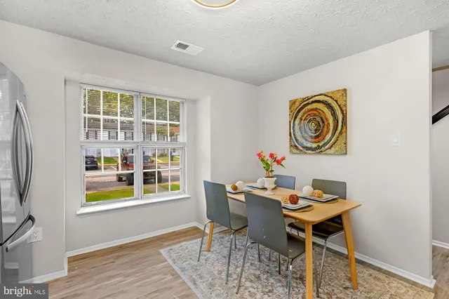 a dining room with furniture and a window