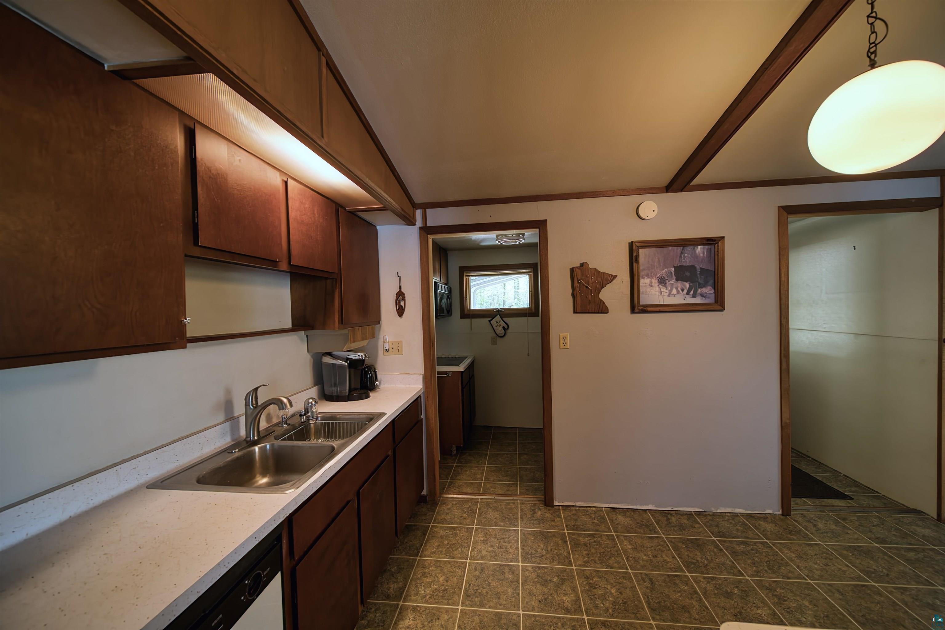 29836 Long Lake Road Danbury, WI 54830 - Photo 8 of 40 Kitchen with dark tile flooring, sink, and decorative light fixtures