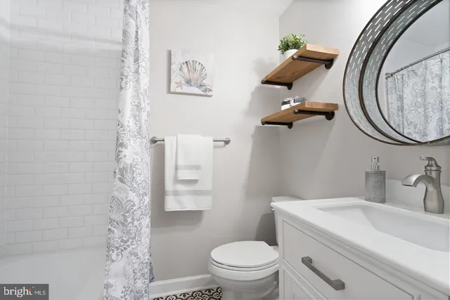 a bathroom with a toilet sink and mirror
