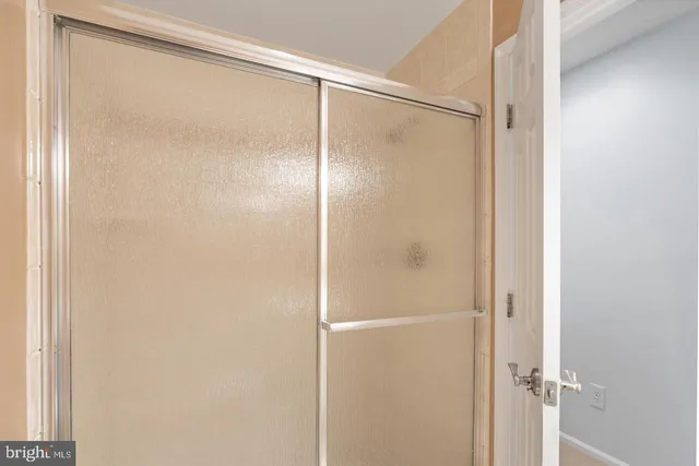 a bathroom with a glass shower door