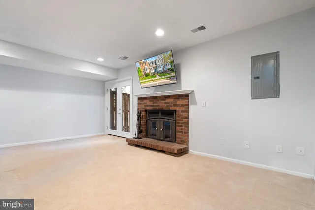 a view of an empty room with a fireplace