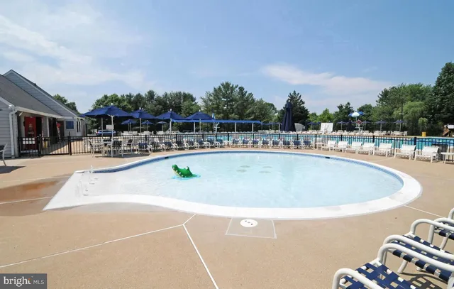 a view of a swimming pool with outdoor seating