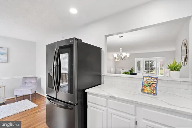 a kitchen with refrigerator and microwave