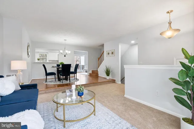 a living room with furniture and a dining table