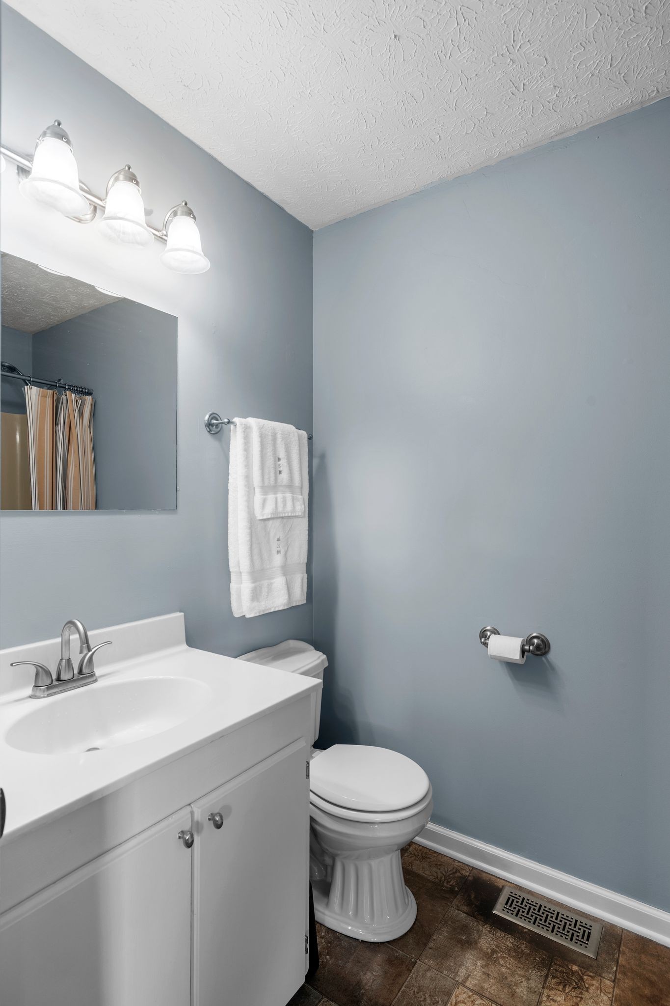 7514 Cox Pike Fairview, TN 37062 - Photo 13 of 37 a bathroom with a toilet sink and mirror