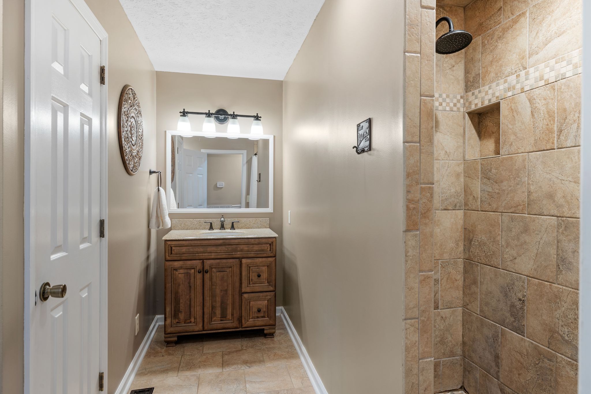 7514 Cox Pike Fairview, TN 37062 - Photo 17 of 37 a bathroom with a sink and mirror