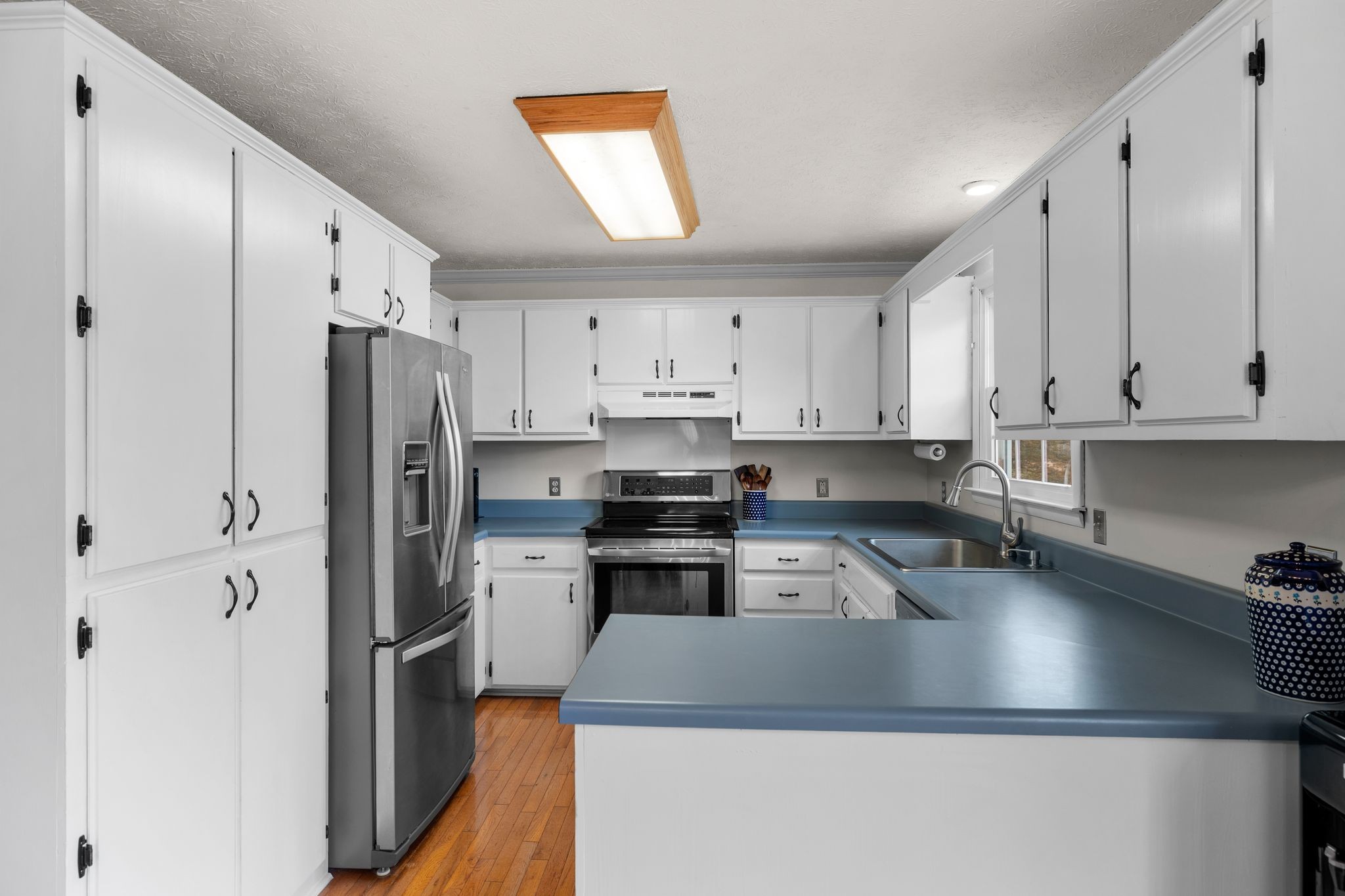 7514 Cox Pike Fairview, TN 37062 - Photo 7 of 37 a kitchen with stainless steel appliances granite countertop a refrigerator sink and stove