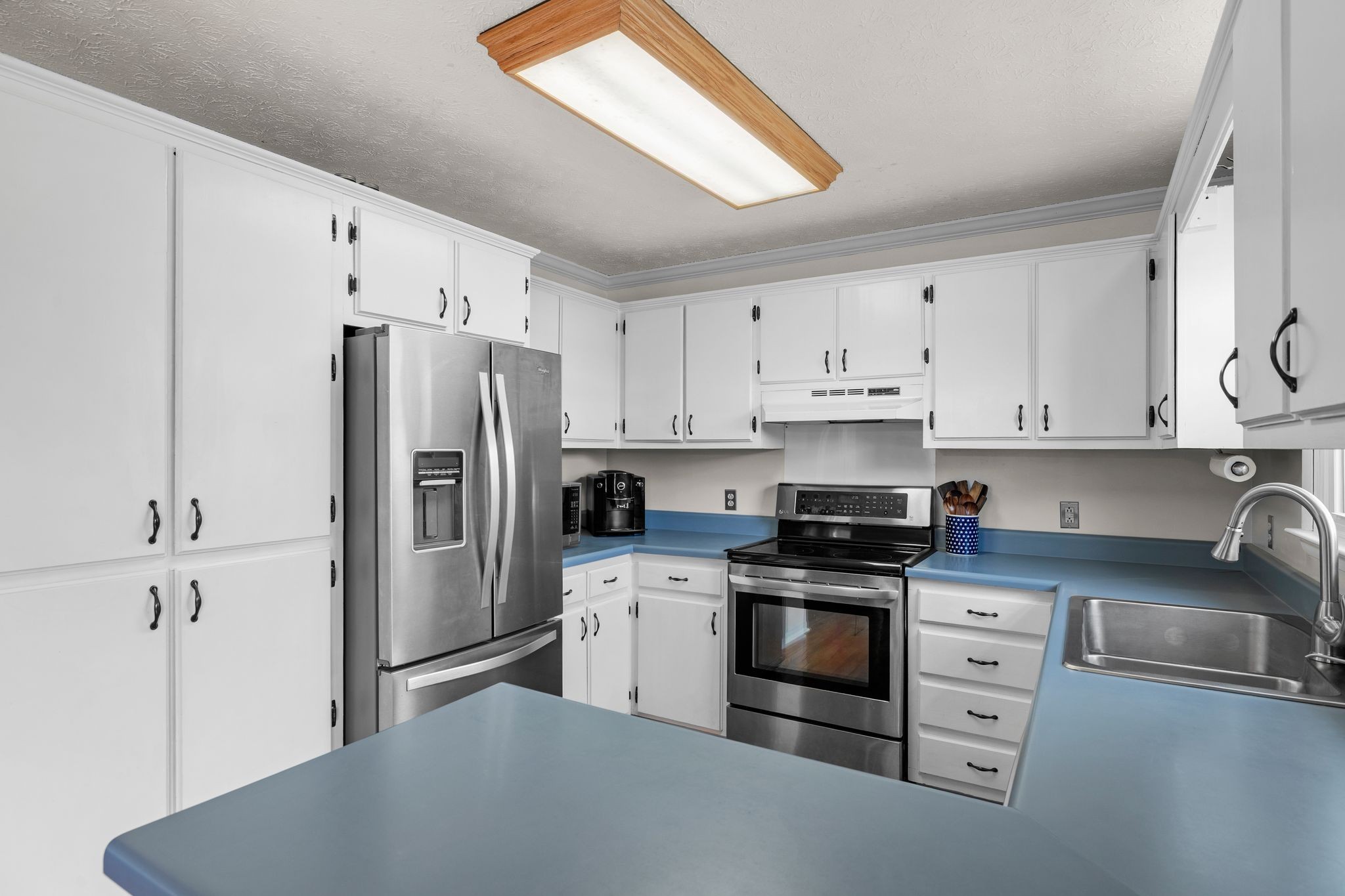 7514 Cox Pike Fairview, TN 37062 - Photo 8 of 37 a kitchen with granite countertop white cabinets and stainless steel appliances