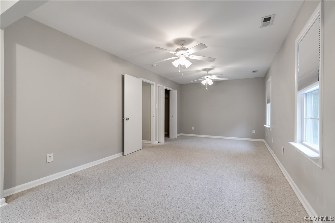 213 Monath Road Chesterfield, VA 23236 - Photo 25 of 38 an empty room with chandelier fan and windows