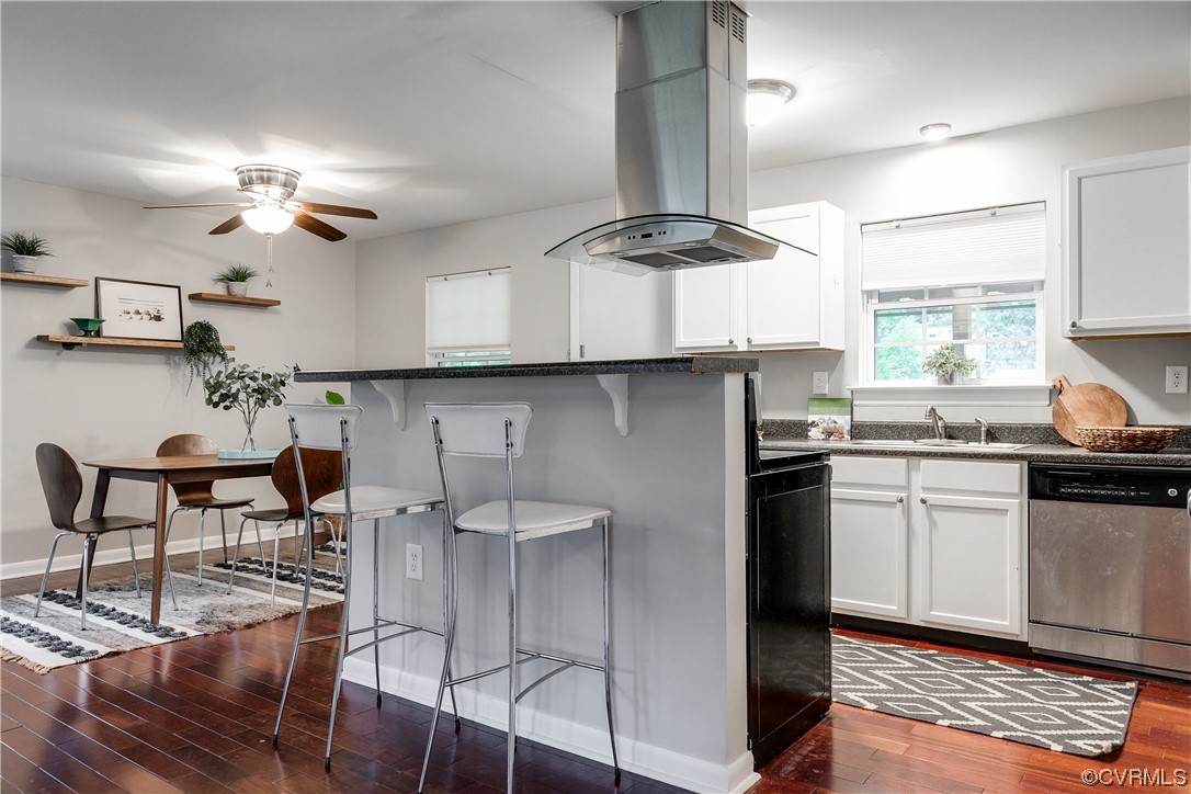 213 Monath Road Chesterfield, VA 23236 - Photo 9 of 38 a kitchen with stainless steel appliances granite countertop a stove a refrigerator a sink a dining table and chairs with wooden floor