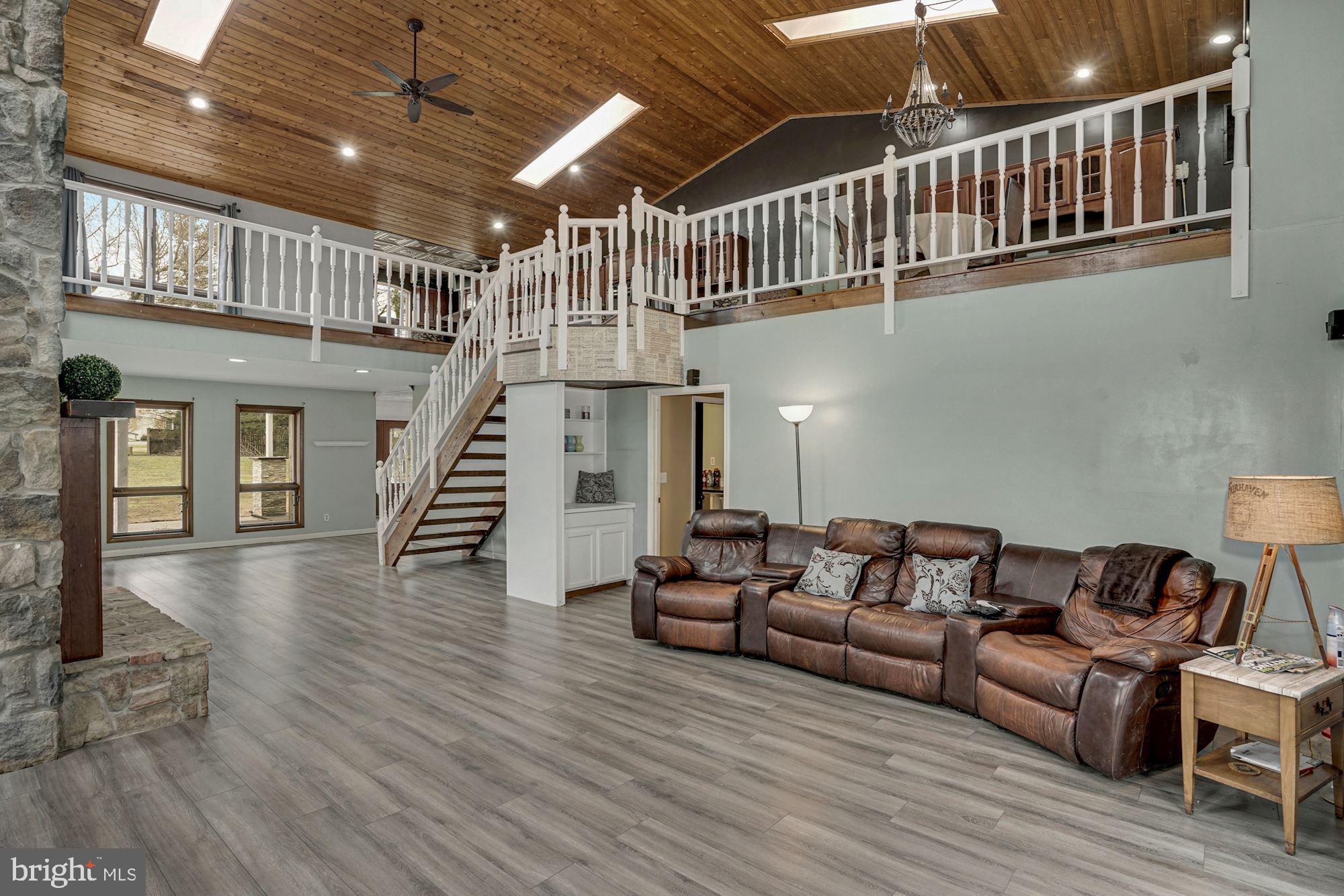 6823 Old Solomons Island Road Friendship, MD 20758 - Photo 6 of 41 Great Room with view of second floor and sky light