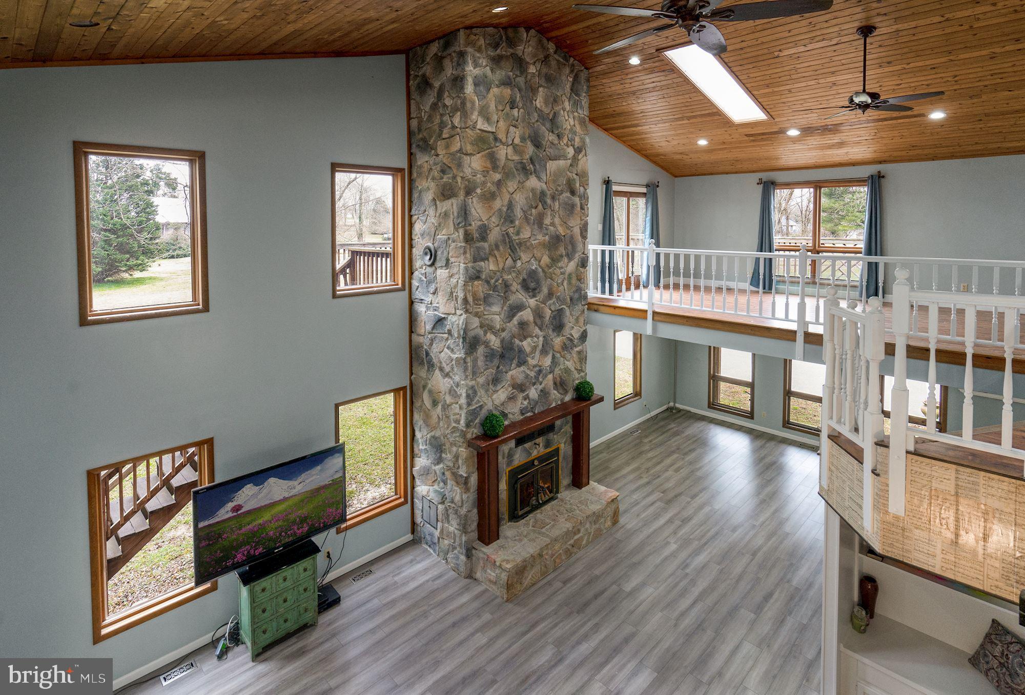 6823 Old Solomons Island Road Friendship, MD 20758 - Photo 8 of 41 2 story fireplace with heat vents and 2 nd floor l