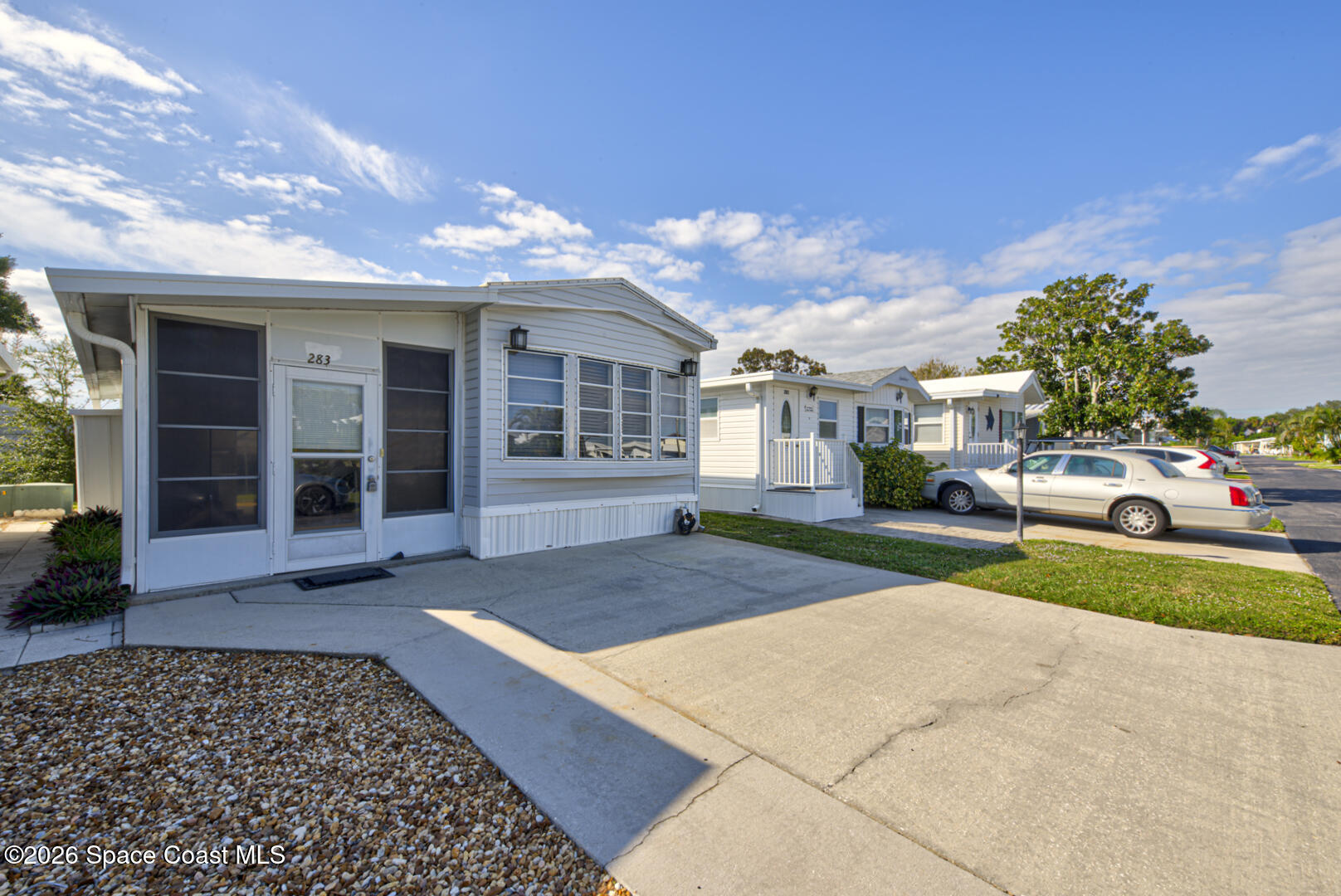 283 Buffalo Place Rockledge, FL 32955 - Photo 3 of 23 a view of a house with a yard and garage