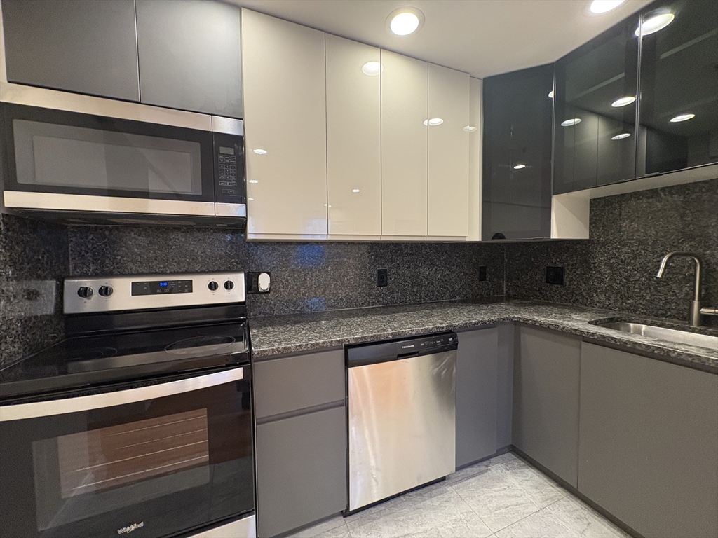 a kitchen with a sink stove and microwave